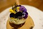potato nest with eel and edible flowers